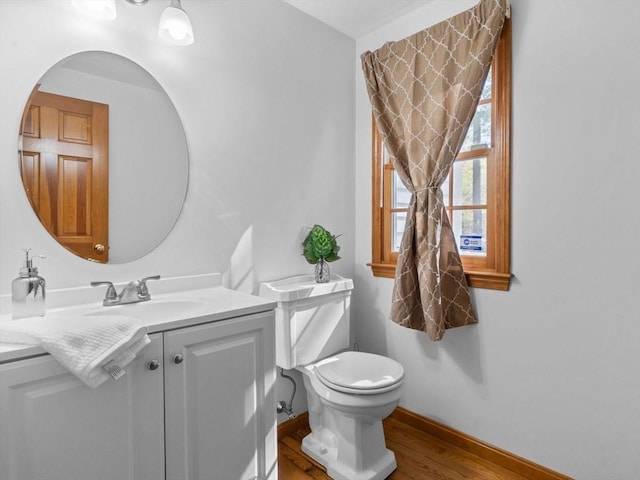 8 Kennedy Ln, Acton, MA 01720 - half bathroom with toilet, vanity, wood finished floors, and baseboards