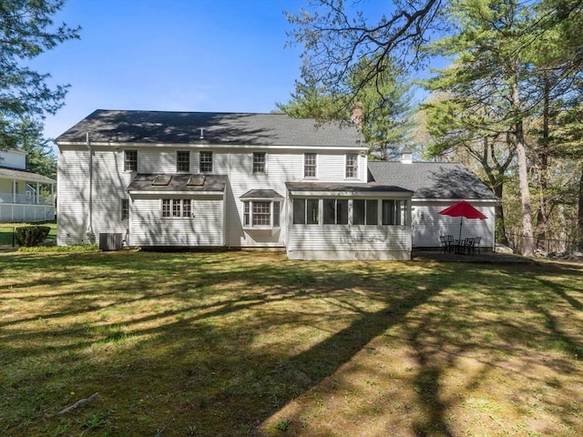 8 Kennedy Ln, Acton, MA 01720 - rear view of house with a sunroom, a chimney, a yard, and central AC