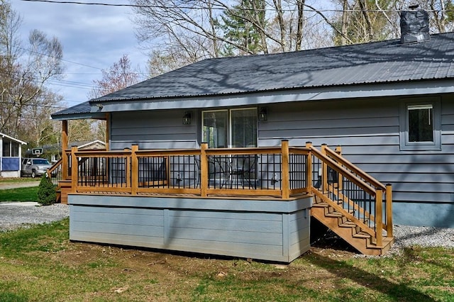 back of property with a deck and metal roof