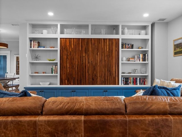living room with visible vents and built in shelves