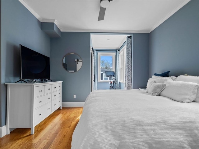 bedroom featuring baseboards, ornamental molding, light wood finished floors, and a ceiling fan