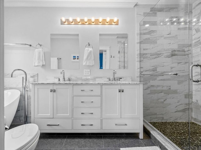 bathroom with double vanity, ornamental molding, a shower stall, and a sink