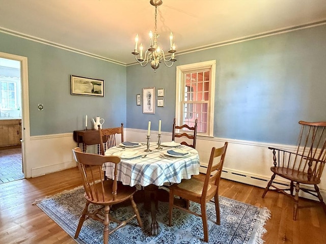 631 Elm St, Dartmouth, MA 02748 - dining room featuring a chandelier, ornamental molding, wood finished floors, and a wainscoted wall