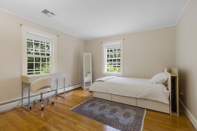 217 Conant Rd, Weston, MA 02493 - bedroom featuring wood finished floors, ornamental molding, and a baseboard heating unit