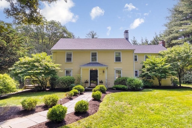 217 Conant Rd, Weston, MA 02493 - colonial home with a chimney and a front lawn