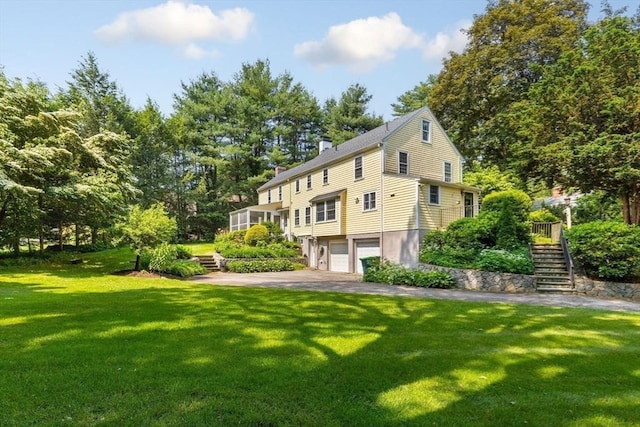 217 Conant Rd, Weston, MA 02493 - back of house with stairs, an attached garage, and a lawn