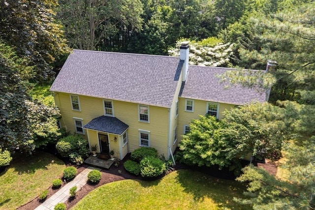 217 Conant Rd, Weston, MA 02493 - view of front facade featuring a chimney, a front yard, and a shingled roof