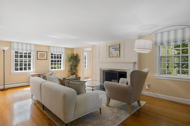 217 Conant Rd, Weston, MA 02493 - living room featuring baseboard heating, a fireplace, and wood finished floors