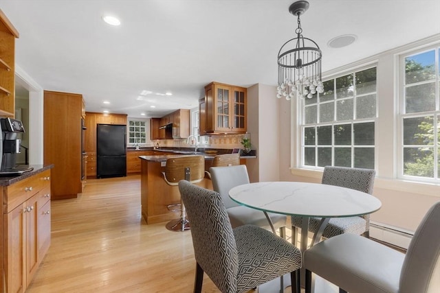 217 Conant Rd, Weston, MA 02493 - dining space featuring light wood finished floors, healthy amount of natural light, recessed lighting, baseboard heating, and a chandelier