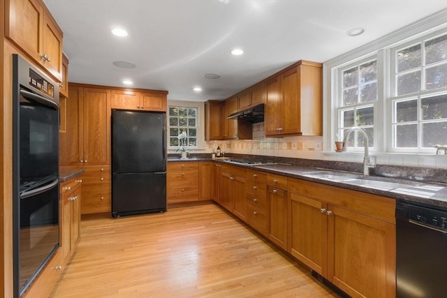 217 Conant Rd, Weston, MA 02493 - kitchen featuring black appliances, brown cabinets, light wood-type flooring, under cabinet range hood, and recessed lighting