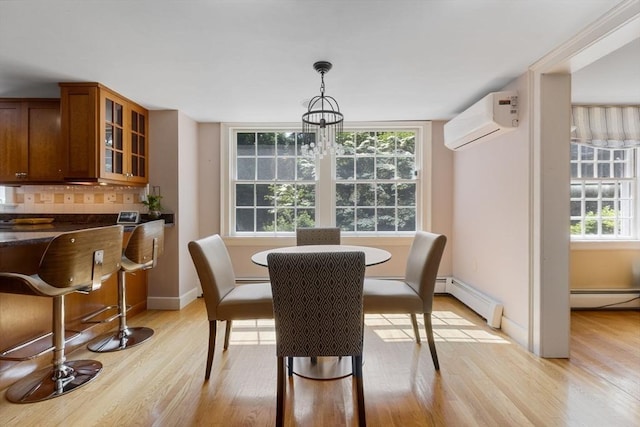 217 Conant Rd, Weston, MA 02493 - dining room with an AC wall unit, light wood-style floors, and a baseboard radiator