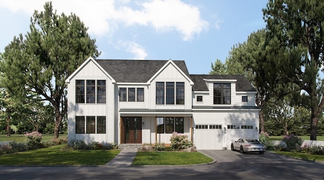 view of front of home featuring a garage and a front yard