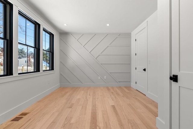 unfurnished room with light hardwood / wood-style flooring