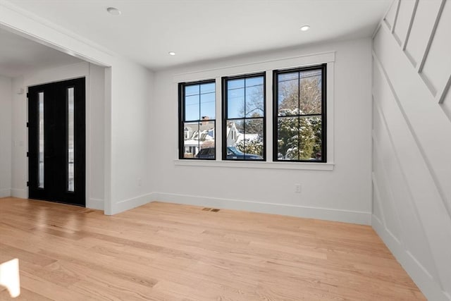 unfurnished room with light hardwood / wood-style flooring