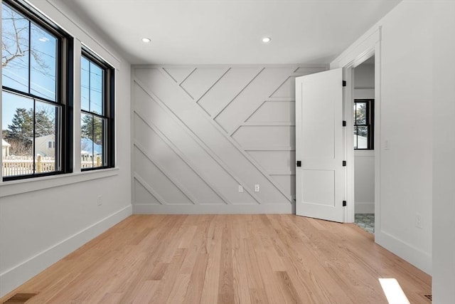 spare room featuring light wood-type flooring