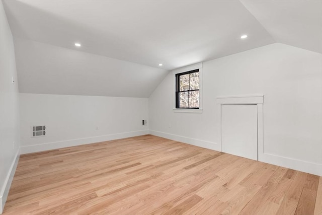 bonus room featuring light hardwood / wood-style flooring and vaulted ceiling