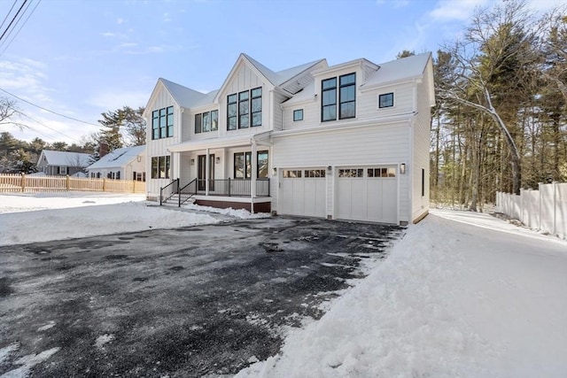 view of front of property featuring a garage and covered porch