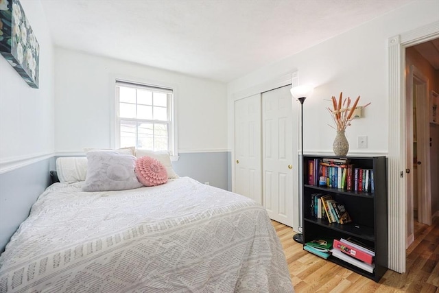 bedroom with light wood-style floors and a closet