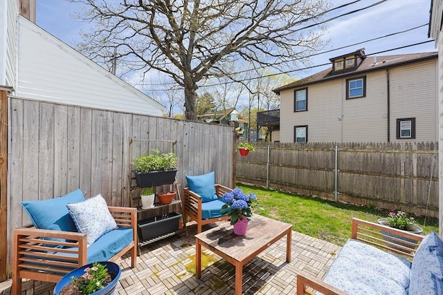 view of patio with an outdoor hangout area and a fenced backyard
