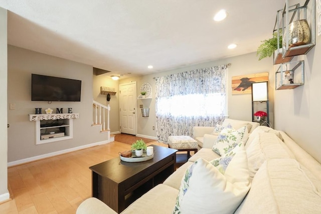 living area featuring recessed lighting, baseboards, stairs, and wood finished floors