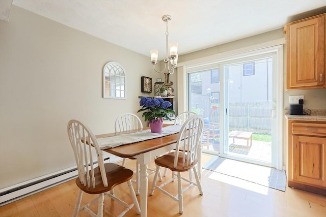 dining room featuring light wood-style flooring, a chandelier, and baseboard heating