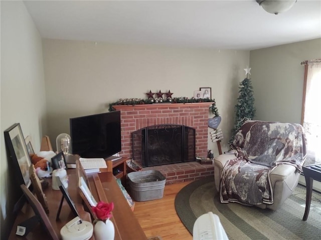 62 Chestnut St, Seekonk, MA 02771 - living area with a brick fireplace and wood finished floors