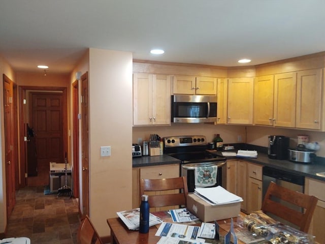 62 Chestnut St, Seekonk, MA 02771 - kitchen with recessed lighting, dark countertops, stone finish flooring, and appliances with stainless steel finishes