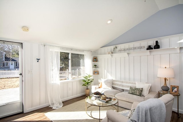 living room with vaulted ceiling and wood-type flooring