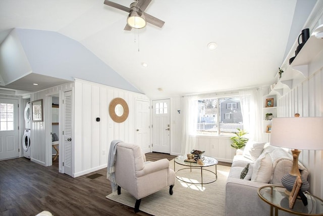 living room with lofted ceiling, washer / dryer, dark wood-type flooring, and ceiling fan