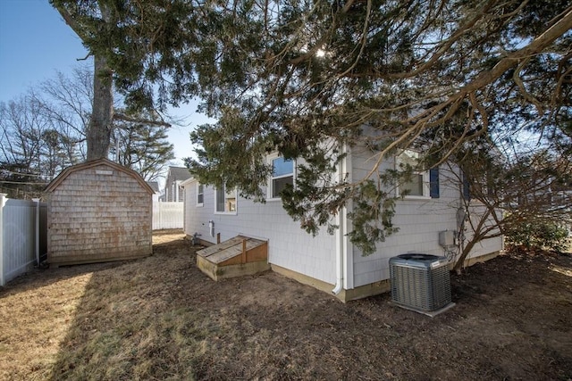 view of side of property featuring a shed and central air condition unit