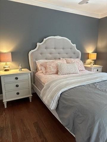 bedroom with ornamental molding and dark wood-style flooring