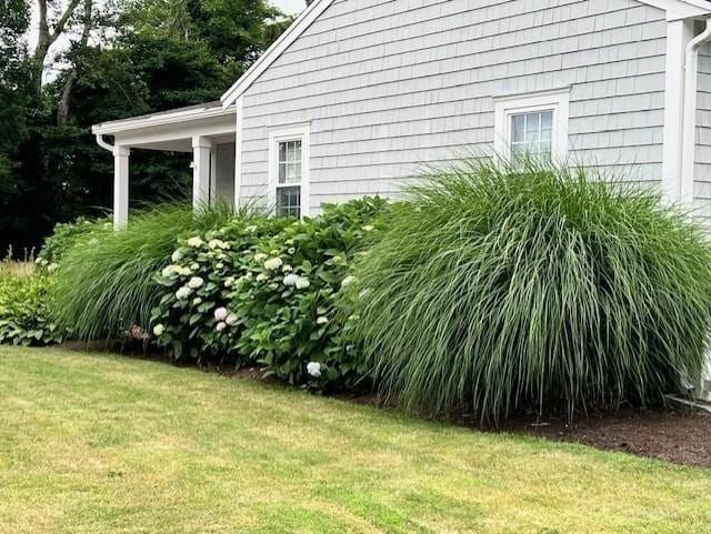 view of property exterior featuring a lawn