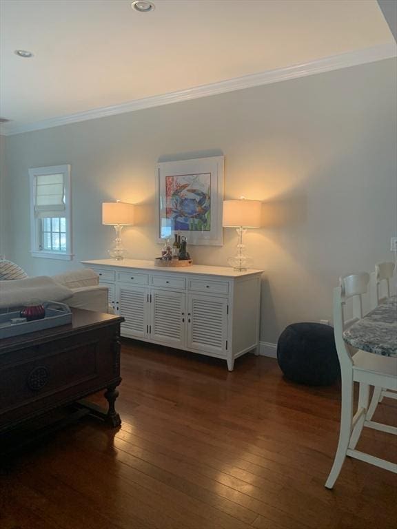 bedroom featuring crown molding and dark wood-type flooring