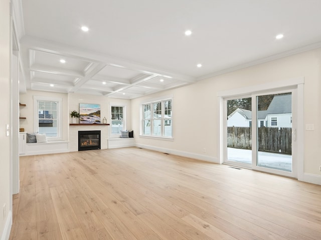 unfurnished living room featuring beam ceiling, light hardwood / wood-style floors, coffered ceiling, and ornamental molding