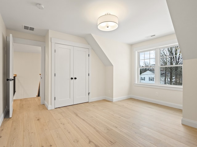 bonus room with light hardwood / wood-style floors