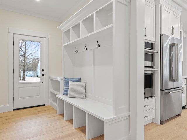 mudroom with light hardwood / wood-style floors and ornamental molding