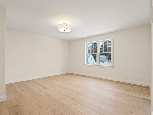 unfurnished room with light hardwood / wood-style floors