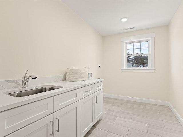 laundry room featuring cabinets, hookup for a washing machine, hookup for an electric dryer, and sink