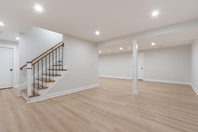 basement with light hardwood / wood-style flooring