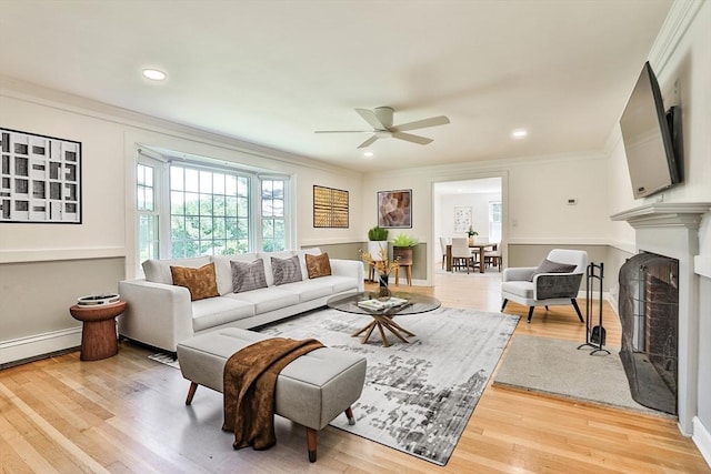 589 Turnpike, Ashby, MA 01431 - living room with a ceiling fan, crown molding, a fireplace with flush hearth, light wood finished floors, and baseboard heating