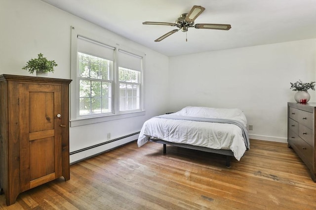 589 Turnpike, Ashby, MA 01431 - bedroom with a baseboard heating unit, wood finished floors, and a ceiling fan