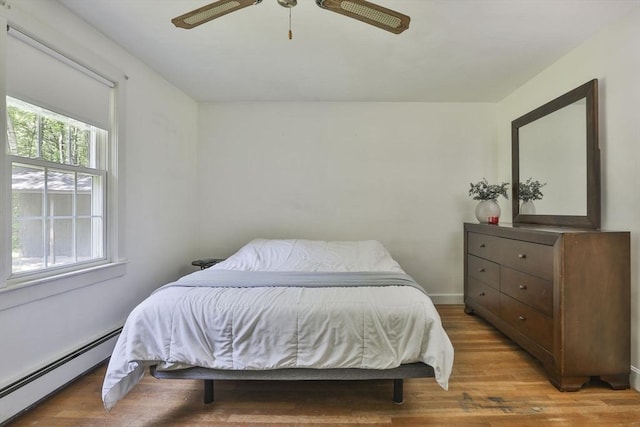 589 Turnpike, Ashby, MA 01431 - bedroom with a baseboard heating unit, light wood-style flooring, and ceiling fan