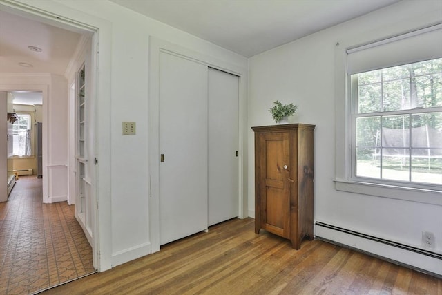 589 Turnpike, Ashby, MA 01431 - bedroom featuring a baseboard radiator, a closet, and wood finished floors