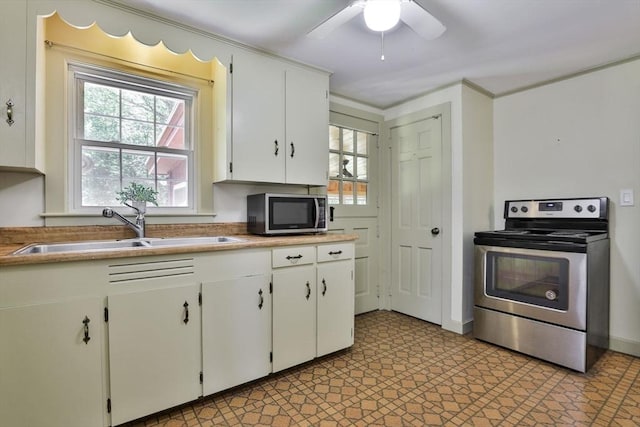 589 Turnpike, Ashby, MA 01431 - kitchen featuring stainless steel appliances, white cabinets, a ceiling fan, and light countertops