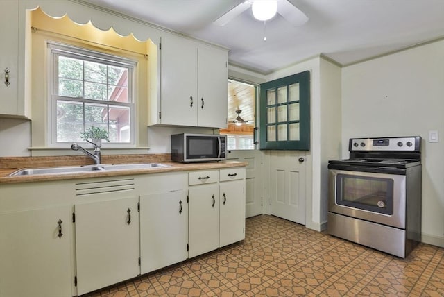 589 Turnpike, Ashby, MA 01431 - kitchen with stainless steel appliances, ceiling fan, white cabinets, and light countertops