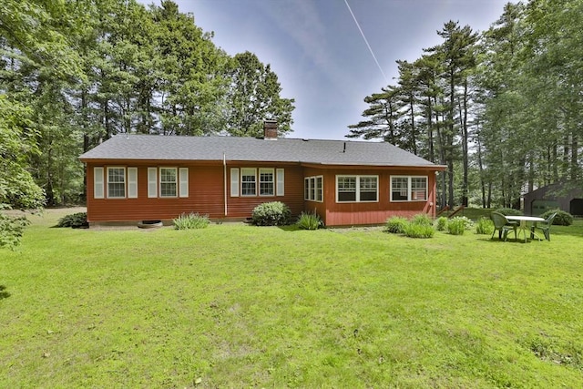 589 Turnpike, Ashby, MA 01431 - back of house with a chimney and a yard