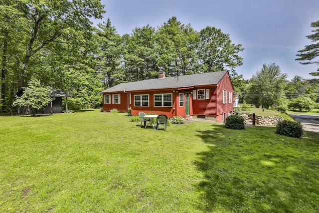 589 Turnpike, Ashby, MA 01431 - back of property featuring a yard, a chimney, and view of scattered trees
