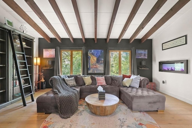 living room featuring healthy amount of natural light, wood finished floors, beam ceiling, and baseboards