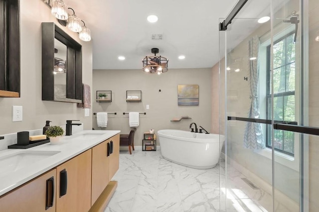 bathroom featuring a stall shower, marble finish flooring, a freestanding bath, recessed lighting, and double vanity