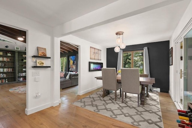 dining room with hardwood / wood-style floors, baseboards, and baseboard heating